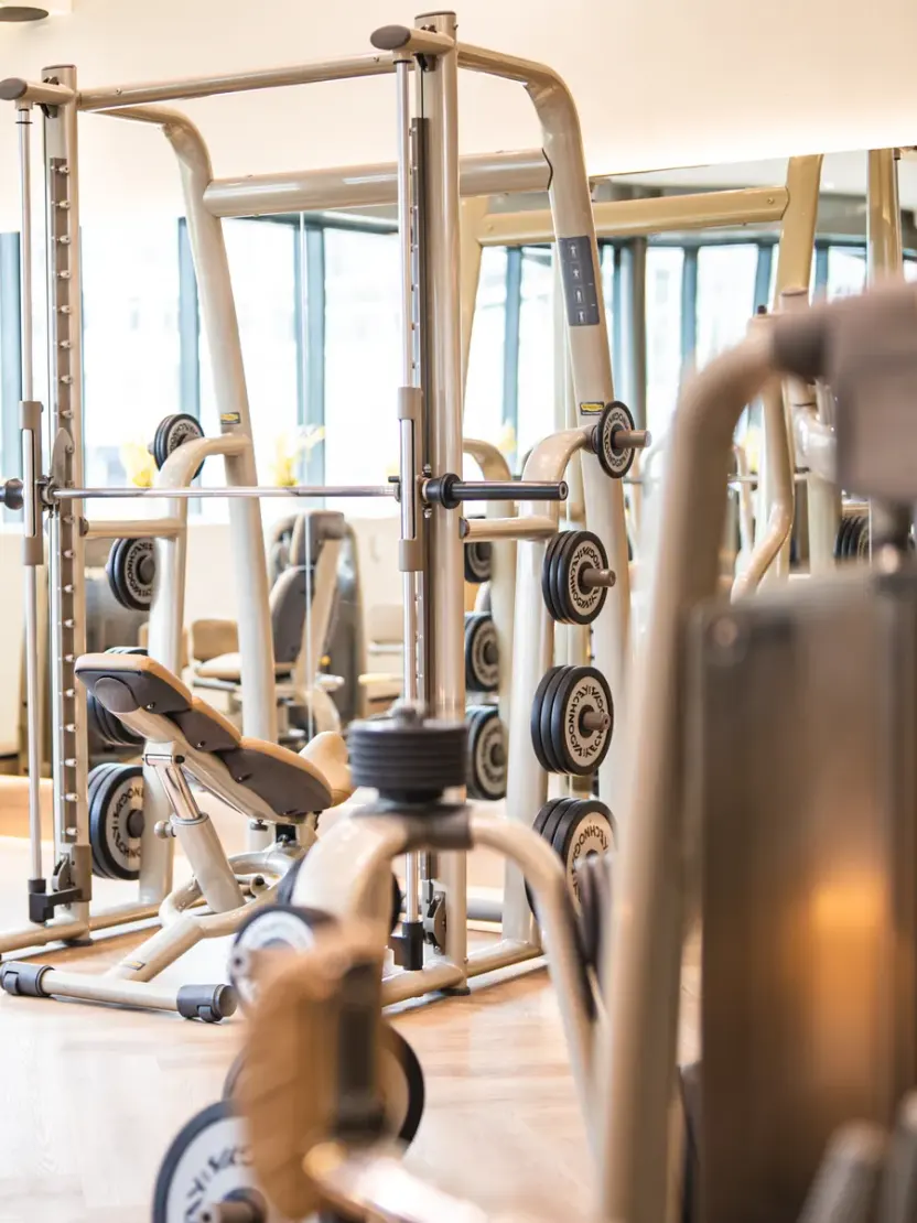 Smith machine and benches in the WellNest gym weight training area