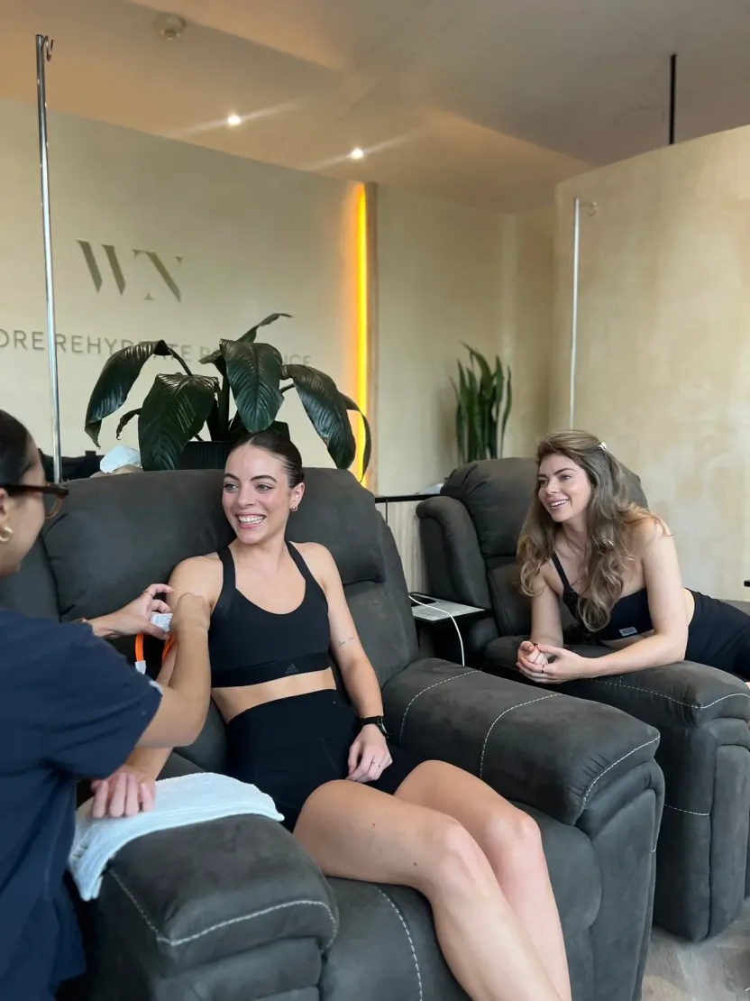 Two clients relaxing in the IV lounge recliners at WellNest Gold, Cape Town